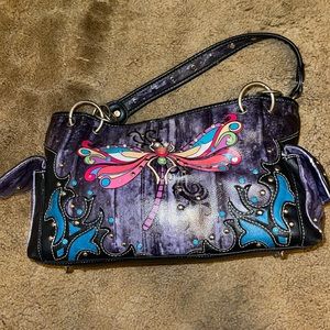 Black dragonfly purse with chains on the strap